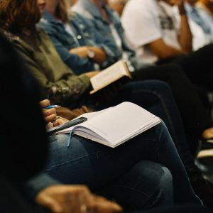 Students taking notes in a lecture hall